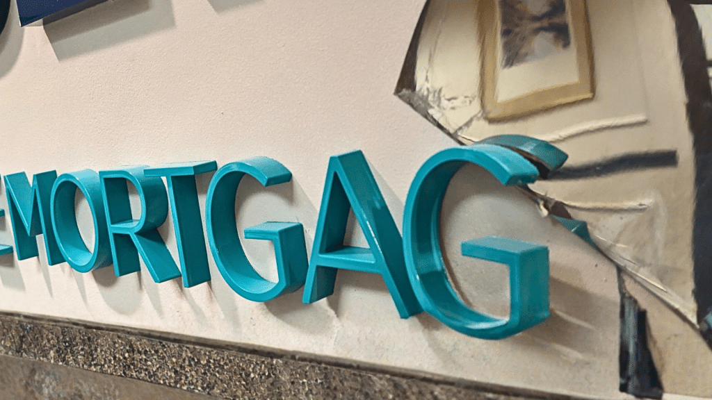 Removing 3D acrylic wall letters from office wall during tenant turnover signage update